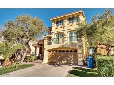 Inviting two-story home with a well-manicured lawn, two-car garage, and charming second story balcony at 8456 Blackstone Ridge Ct, Las Vegas, NV 89139