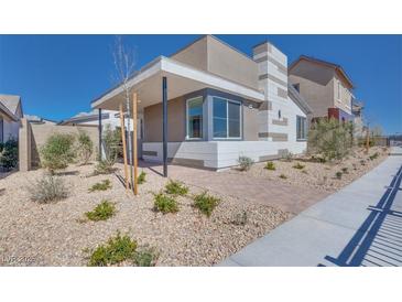 A modern home showcasing a stylish exterior with patterned accents and low-maintenance landscaping at 990 Golden Summit Dr, Las Vegas, NV 89138