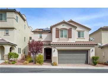 Charming two-story home with a two-car garage, desert landscaping, and a cozy front entrance at 10722 Red Badge Ave, Las Vegas, NV 89166