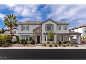 Beautiful two-story home with a well-manicured yard and stone accents at 2001 Alcova Ridge Dr, Las Vegas, NV 89135