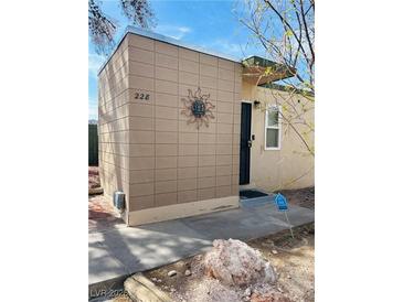 Charming home featuring a decorative sun adornment and minimalist landscape at 228 E Van Wagenen St, Henderson, NV 89015