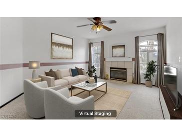 Bright living room with fireplace, neutral-toned furniture, and large windows allowing lots of natural light at 4555 E Sahara Ave # 280, Las Vegas, NV 89104