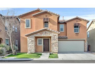 Charming two-story home featuring stone accents, a well-manicured lawn, and an attached two-car garage at 7200 Mineral Park Ave, Las Vegas, NV 89179