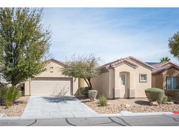 Charming single-story home featuring low-maintenance landscaping and an attached two-car garage at 7726 Coast Jay St, North Las Vegas, NV 89084