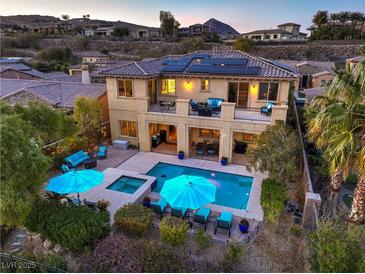Stunning backyard featuring a pool, spa, balcony, and solar panels for energy efficiency at 79 Rezzonico Dr, Henderson, NV 89011