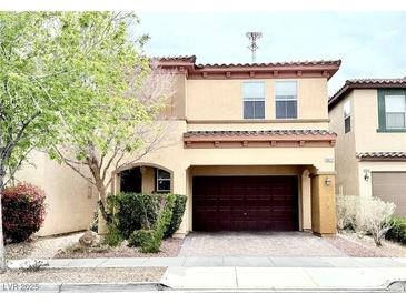 Charming two-story home features a well-maintained front yard and a two-car garage at 8477 Orly Ave, Las Vegas, NV 89143