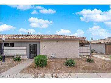 Cozy single-story home featuring a stucco exterior, desert landscaping, and a tile roof against a blue sky at 255 N Lamb Blvd # F, Las Vegas, NV 89110