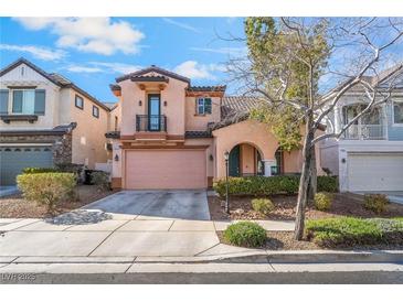 Two-story home with a pink garage door, archway and a small balcony on a sunny day at 2851 Glistening Grove Ave, Henderson, NV 89052