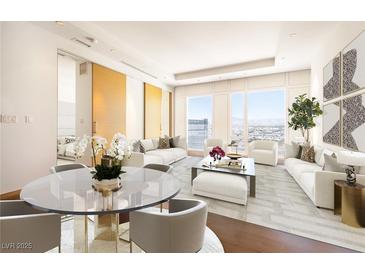 Bright living room with hardwood floors, modern furniture, and city views from large windows at 3750 Las Vegas Blvd # 3301, Las Vegas, NV 89158