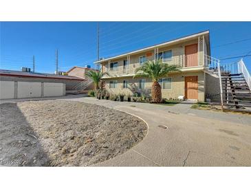 Inviting two-story apartment complex with mature landscaping, palm trees, and ample parking at 5228 Pebble Beach Blvd, Las Vegas, NV 89108