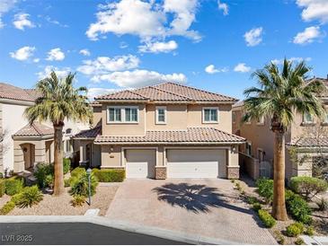 Beautiful two-story home with a two-car garage, palm trees, and a well-maintained lawn at 5578 Holcomb Bridge Ct, Las Vegas, NV 89149