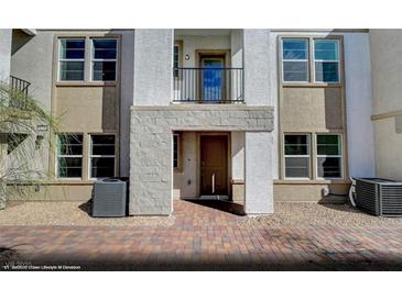 Inviting townhome showcasing a private balcony and welcoming brick entrance at 5733 Crenellated St # Lot 67, Las Vegas, NV 89148