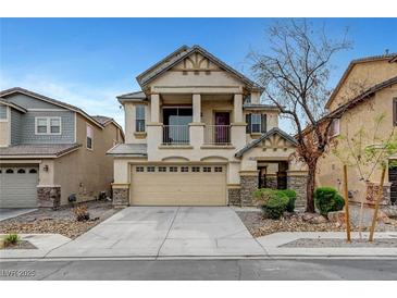 Inviting two-story home featuring a charming balcony, stone accents, and a well-maintained front yard at 5829 Feral Garden St, North Las Vegas, NV 89031