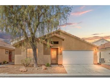 Charming single-story home with desert landscaping and a two-car garage under a colorful sunset at 6037 Soft Springs Ave, Las Vegas, NV 89130
