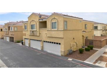 Attractive condo with a two-car garage and desert landscaping at 6325 Snap Ridge St # 102, North Las Vegas, NV 89081