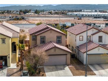 Two-story home featuring a tan exterior, brown roof and an attached two-car garage at 8646 Mesquite Hills St, Las Vegas, NV 89139