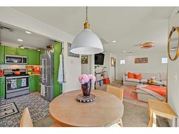 Open living room features bright green cabinets, stainless appliances, and modern decor at 8868 Intertwine, Las Vegas, NV 89149