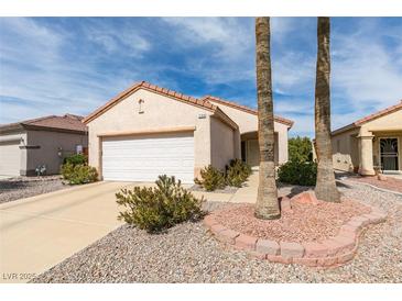 Charming single-story home with a two-car garage and a well-maintained desert landscape at 2194 King Mesa Dr, Henderson, NV 89012