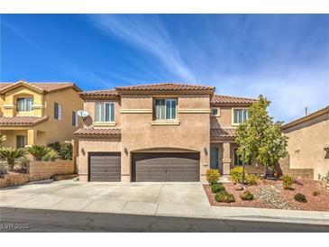 Charming two-story home with desert landscaping, a tile roof, and a two-car garage at 260 Pioneers Peak, Henderson, NV 89002
