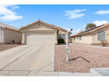 Charming single-story home featuring a two-car garage, desert landscaping, and a neutral color palette at 2883 Mount Hope Dr, Las Vegas, NV 89156