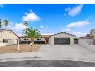 Charming single-story home featuring a spacious driveway and a well-manicured front yard with mature palm tree at 3228 Robin Cir, Las Vegas, NV 89121