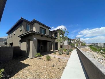 Charming home with desert landscaping, covered entry, and walkway to other units at 492 Pear Lake St, Las Vegas, NV 89138