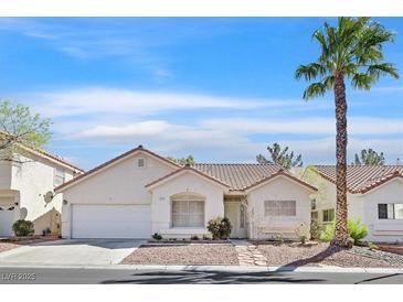 Charming single-story home featuring stucco exterior, desert landscaping, and a classic tile roof at 4932 Forest Oaks Dr, Las Vegas, NV 89149