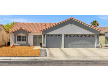 Charming single-story home featuring a terra cotta roof, two-car garage, and low-maintenance landscaping at 5227 Zebra Ct, North Las Vegas, NV 89031
