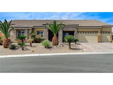 Charming single-story home featuring a three-car garage and desert landscaping at 6971 Moaning Cavern St, Las Vegas, NV 89131