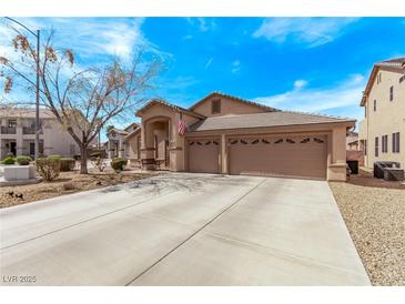 Charming single-story home showcasing a well-maintained front yard and a spacious three-car garage at 803 Fetter Ct, Henderson, NV 89052