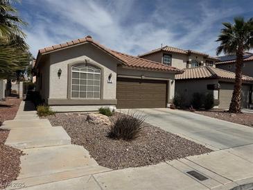 Charming single-story home with a well-maintained desert-style front yard and a two-car garage at 976 Dancing Vines Ave, Las Vegas, NV 89183