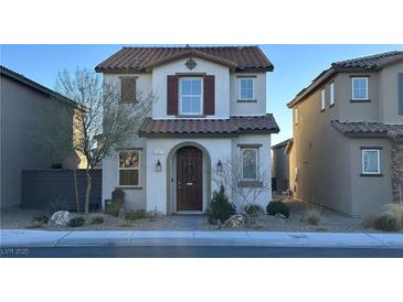 Charming two-story home with a tile roof, complemented by desert landscaping and a welcoming front entrance at 1027 Brilliant Meadow Ave, North Las Vegas, NV 89086
