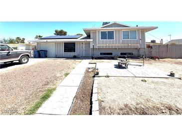 Charming two-story home featuring solar panels and a spacious front yard with a sitting area at 2508 Alfa Cir, Las Vegas, NV 89142