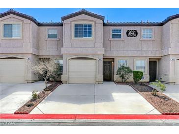 Charming townhome featuring a private garage and well-maintained front landscaping at 2621 Adelante Ave # 104, Las Vegas, NV 89106