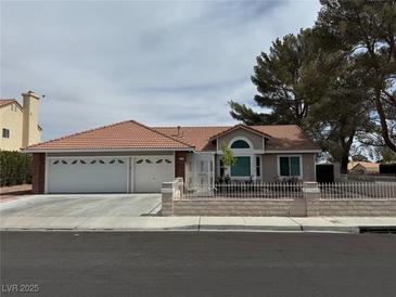 Charming single story home with an attached three car garage, tile roof, and neutral-tone exterior at 3316 Cutty Sark St, Las Vegas, NV 89117