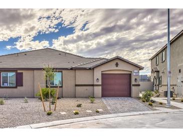 Charming single-story home with a well-manicured front yard and a two-car garage at 7910 Pandora Sky St # 271, North Las Vegas, NV 89084