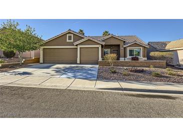 Inviting single-story home featuring a two-car garage and desert landscaping for low maintenance living at 917 Pigeon Forge Ave, Henderson, NV 89015