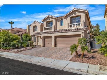 Charming stucco two-story home featuring a three-car garage, tile roof and a well-maintained landscaped yard at 9967 Pipestone St, Las Vegas, NV 89141