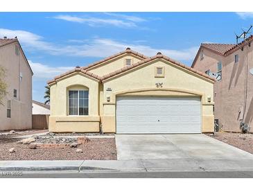Charming one-story home featuring a well-maintained front yard, desert landscaping, and a two-car garage at 100 Beaver Falls Ave, Las Vegas, NV 89123