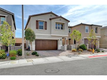 Charming two-story home featuring a well-manicured lawn and an attached two-car garage at 10397 Skye Canyon Falls Ave, Las Vegas, NV 89166