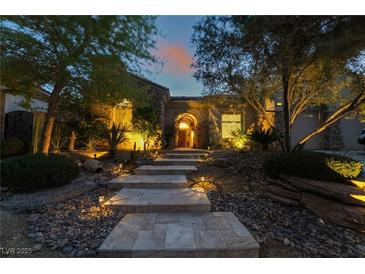 Inviting stone steps lead to the illuminated entryway of this charming home at 5 Circa De Montanas, Henderson, NV 89011