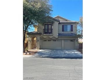 Charming two-story home with a three-car garage, decorative shutters, and a small balcony on the second story at 5937 Armide St, North Las Vegas, NV 89081