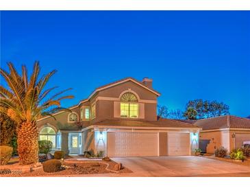 Charming two-story home with a well-manicured front yard and a three car garage at 6129 Flaming Arrow Rd, North Las Vegas, NV 89031