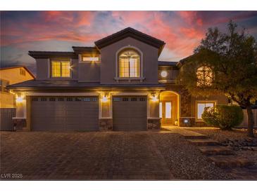 Beautiful two-story home with a three-car garage and meticulously maintained landscaping at 7338 Flying Pegasus Ct, Las Vegas, NV 89131