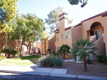 Lovely condo complex with mature landscaping and inviting walkways at 9325 W Desert Inn Rd # 110, Las Vegas, NV 89117