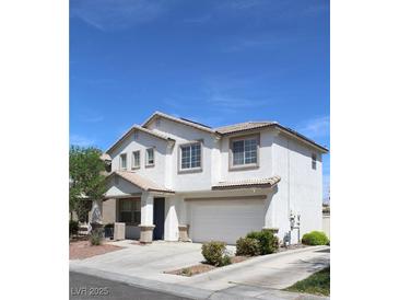 Charming two-story home with a two car garage and a well-manicured front yard at 9792 Cordova Vista Ct, Las Vegas, NV 89183