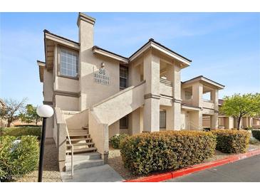 Inviting condo exterior featuring well-maintained landscaping and staircase leading to upper units at 9901 Trailwood Dr # 2144, Las Vegas, NV 89134