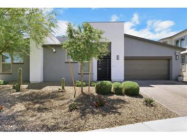 Beautiful single-story home with modern gray stucco exterior and a low-maintenance desert landscape at 1609 Dream Canyon Ave, North Las Vegas, NV 89084