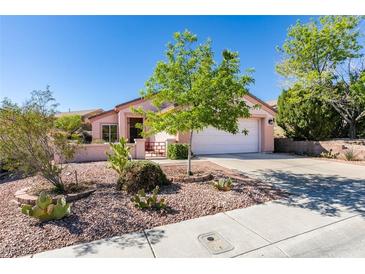Charming single-story home with desert landscaping and a two-car garage on a sunny day at 2037 Poppywood Ave, Henderson, NV 89012