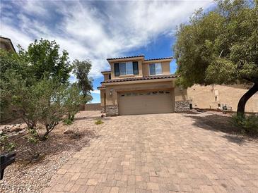Charming two-story home with a brick driveway and a well-maintained front yard at 2773 Drumlanrig St, Henderson, NV 89044